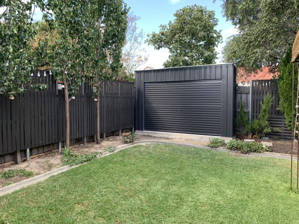 Roller Door Storage Shed In Back Garden